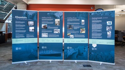 An exhibit on disasters is seen in a library.