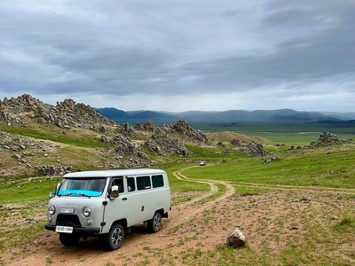 Vans on a mountainous road.