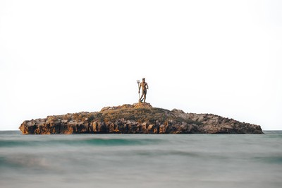 A statue standing on a small island.