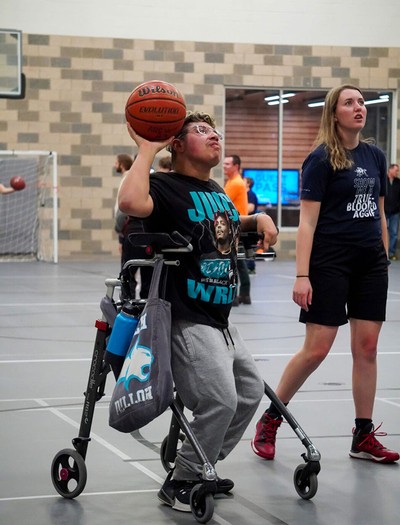 A person shooting a basketball.