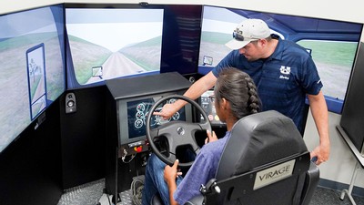 People using a truck simulator.