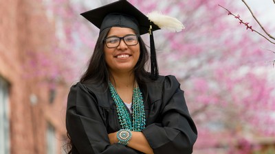 A student in graduation robes.