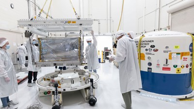 Lab workers working on space exploration equipment.