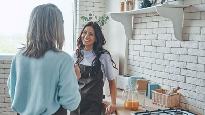 Two women talking in a home.