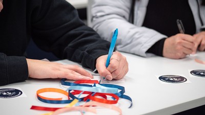 People writing messages on scraps of paper.