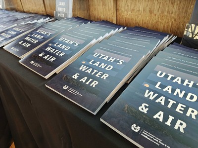 Several copies of a booklet on a desk.