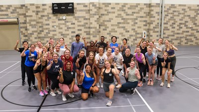 A group photo of students in a gym.