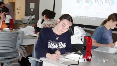 Student using microscope.