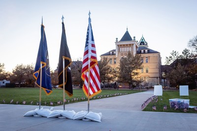 The Utah flag, the prisoner of war and missing in action flag, and the American flag on the USU Quad