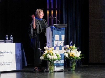A woman gives an address at graduation.