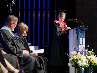A woman gives an address at graduation.