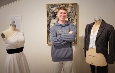 Jeremy Case standing in a museum's fashion exhibit.