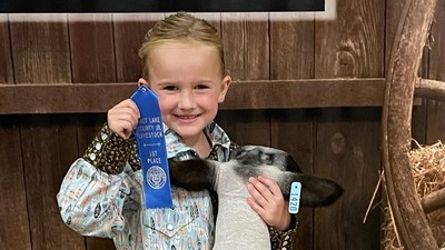 USU 4-H youth with a first-place ribbon.