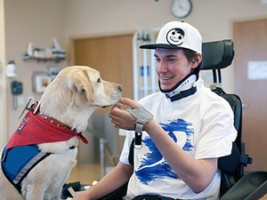 A young man with a therapy dog