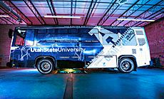 the Aggie Bus in its gargage with wireless transfer system