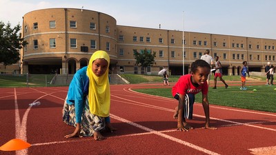 two children running on a track.