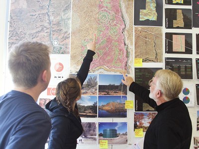 student looking at landscape drawings