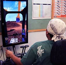 A USU Eastern Blading student at the wheel of hydraulic excavator