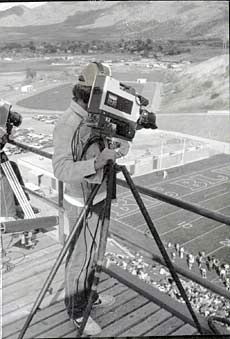 A Cable Company staff member filming an Aggie football game