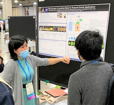 Chihiro Naruke presents a poster of her research.