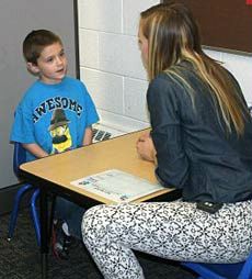 a student and teacher work together in USU's ASSERT program