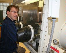 A nitrogen-filled glove box with glass vials of synthetic compounds