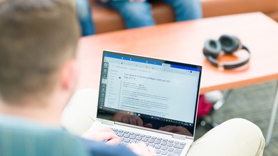 A computer screen displays a written assignment.