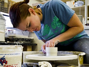 a USU student in the ceramics studio