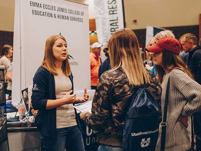 A college ambassador talks with a group of prospective students.