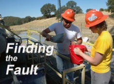 Sarah Draper and Rafael Almeida scooping expelled drilling mud 