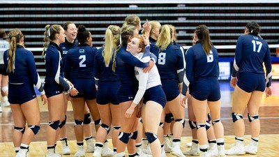 USU Eastern volleyball team celebrates on the court.