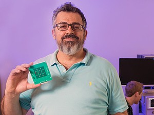 USU engineering professor Bedri Cetiner holding a reconfigurable antenna