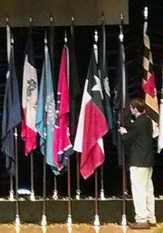 USU's Brian Higginbotham with Utah flag at Extension centennial conference