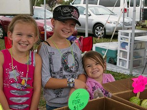 young girls at a farmers market booth