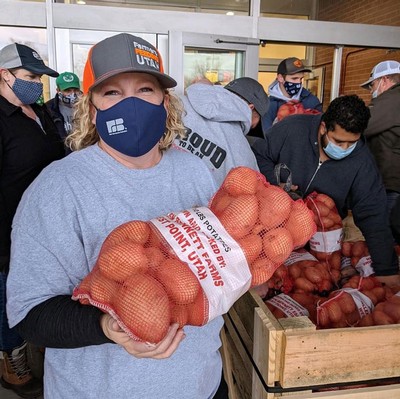 A volunteer hands out food at a previous Farmers Feeding Utah “Miracle Projects.”