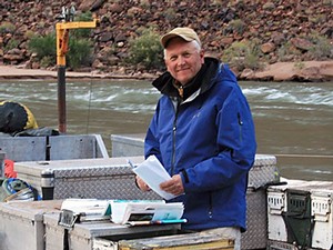 USU professor Jack Schmidt on a boat