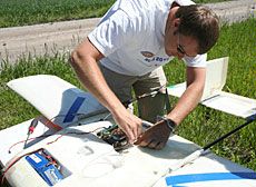 USU student with USU designed and built fix-wing craft