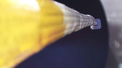 A long inflatable boom extends from a satellite