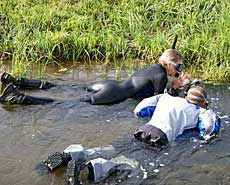 USU grad student and advisor snorkel in a stream for research