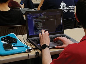 A student in a computer session learning coding