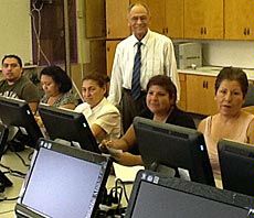 USU Extension's Hector Mendiola in technology multicultural center with students