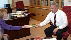 Noelle Call presents a copy of When the Emperor was Divine to President Albrecht