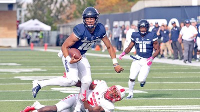 Utah State quarterback Jordan Love scrambles for a short gain.