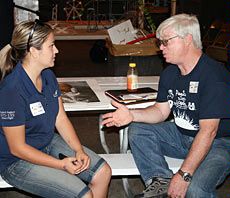 USU physics professor J.R. Dennison and a volunteer discuss USU Physics Day