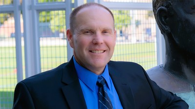 A man stands posing for a photo.