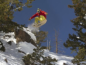 Jeremy Jensen executing a jump while powdersurfing