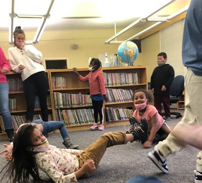 Karli Ludwig teaches a yoga class to elementary students.