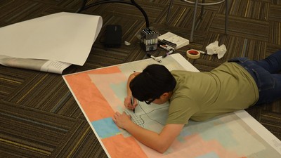 Student Amy Cervantes working on visuals for the design charrette presentation.