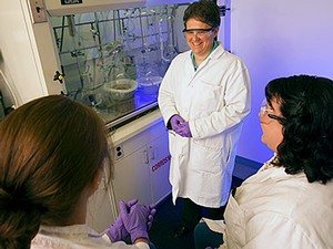 Chemist Lisa Berreau in lab with students