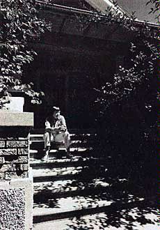 May Swenson sitting on the steps of the family home in Logan